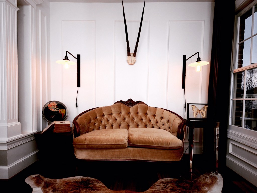 Vintage sofas and our beloved kudu anchored our design for the Cottage at Sweet Clover.